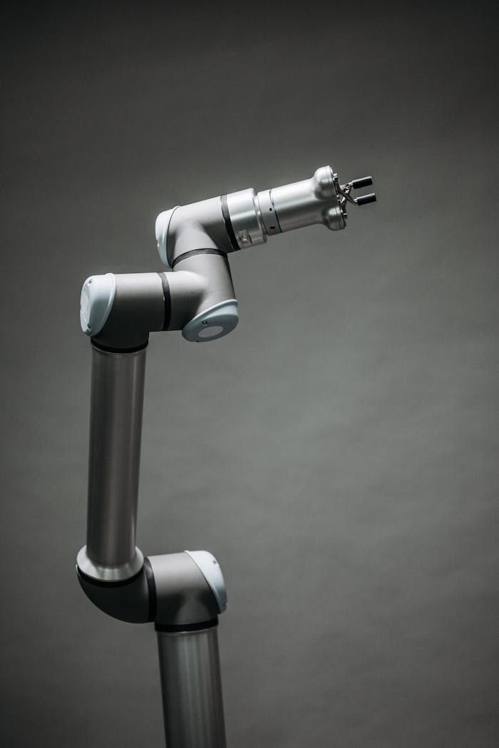An industrial robotic arm on a neutral background, showcasing modern technology and innovation.